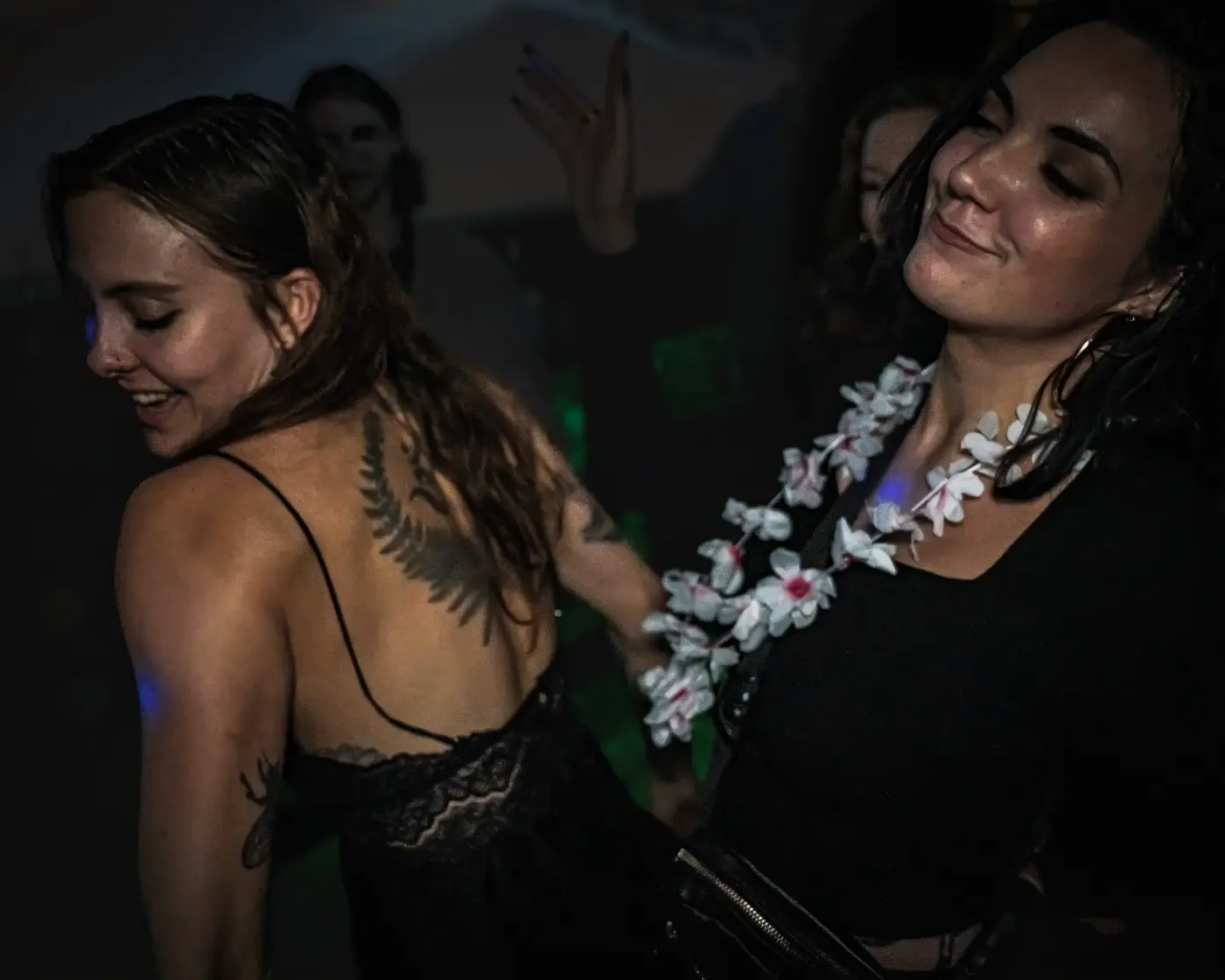 Two attendees dancing together at a Pluto Events party