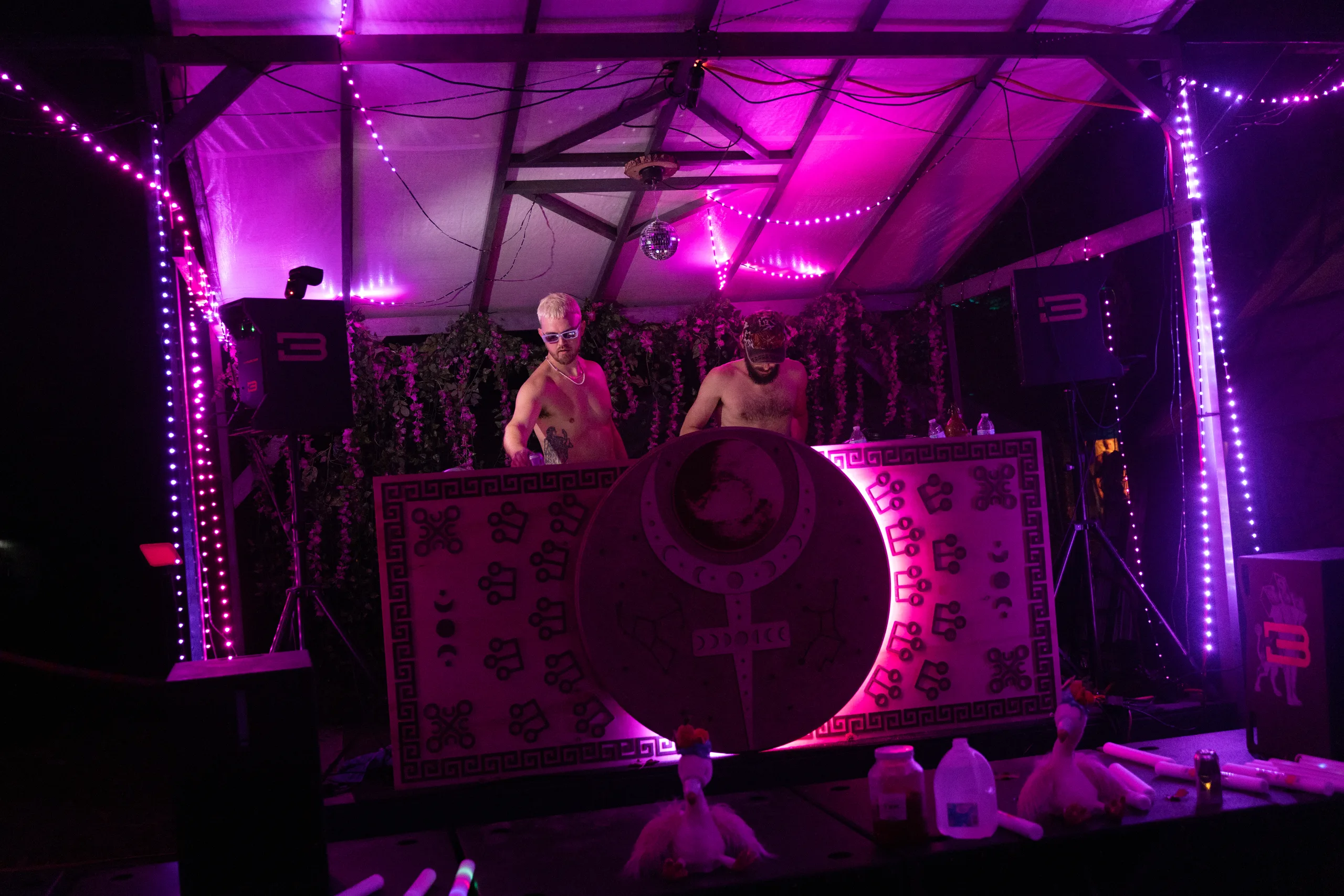 Two DJs performing on a stage illuminated by purple lights at ManaFest 2026